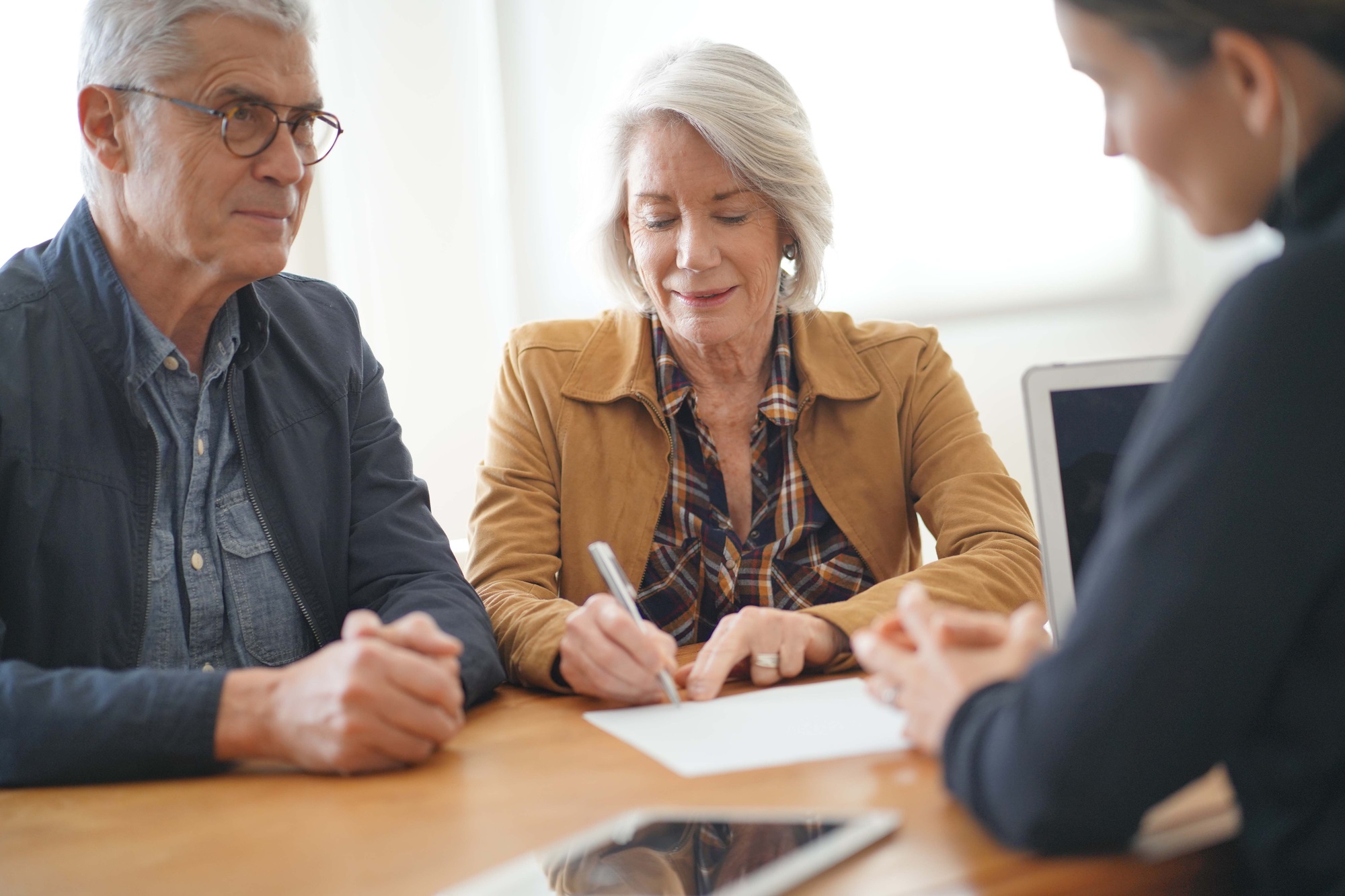 Elderly-modern-couple-signs-housing-contract-agreement