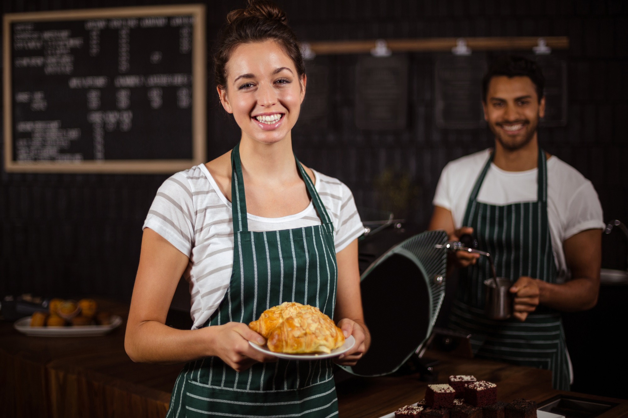 Barista sonriente sosteniendo croissants - Importe del salario mínimo interprofesional en el 2023